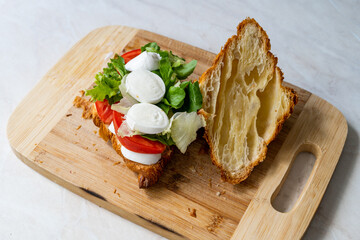 Caprese Croissant Sandwich with Mozzarella Cheese and Tomatoes.