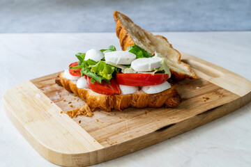 Caprese Croissant Sandwich with Mozzarella Cheese and Tomatoes.