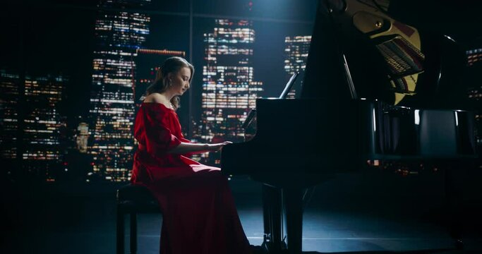 Evening in a Private Concert Hall, Young Female Pianist Plays the Grand Piano With Grace and Precision. Audience Is Absorbed by the Beauty and Technical Melody of Her Music. Zoom Out From Her Hands