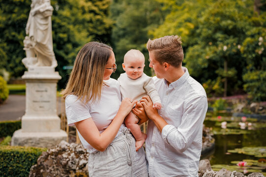 Young family of 3 with small baby at the park