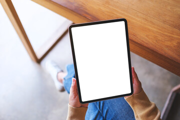 Top view mockup image of a woman holding digital tablet with blank desktop screen