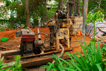 Ground water hole drilling machine working in a construction site for drilling piles