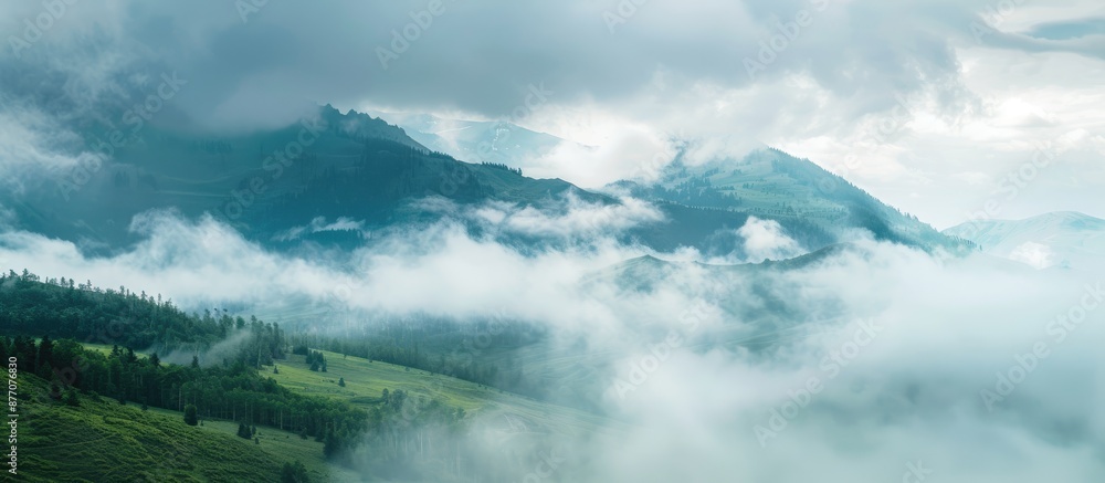 Poster mountain landscape with copy space image featuring drifting low clouds.