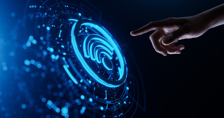Human hand presses a virtual button on screen with Wi-Fi icon. Network and wireless Technology...