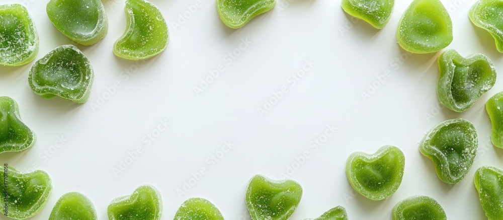Aufkleber An array of green gummy candies presented in a frame on a white background in a top-down perspective offers room for text or design in the copy space image.