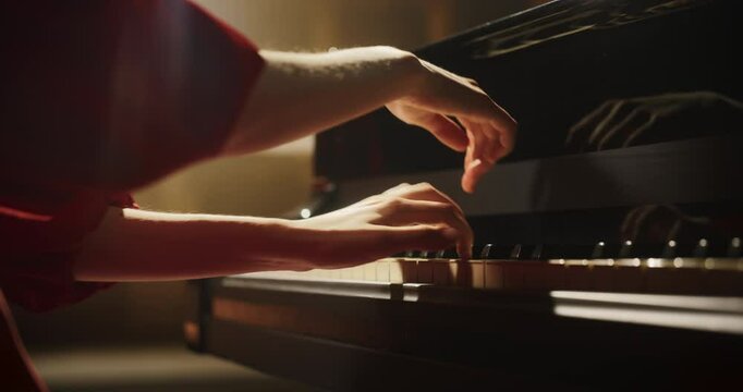 Close Up on Pianist Hands Playing an Exciting Jazz Melody on a Black Grand Piano. Anonymous Artist is Focused on Creating Beautiful Instrumental Song as She Practicing Playing on a Keyboard