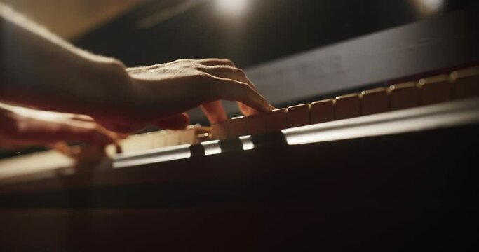 Classical Piano Concert: Under the Spotlight, Close Up on Pianist Hands Delivering a Powerful Performance on the Grand Piano. Her Passionate Playing Leaving the Audience Happy