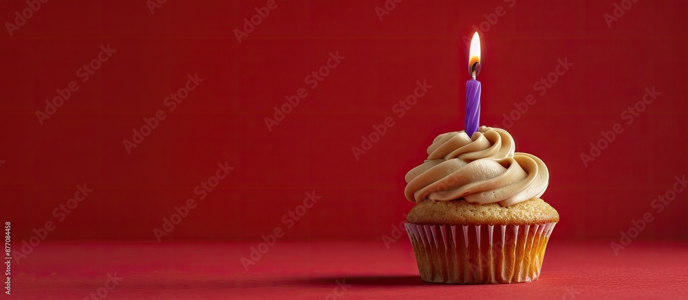 Poster a caramel cupcake topped with a lone purple candle displayed against a red background, providing amp