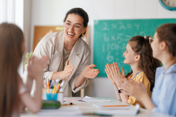 Happy kids and teacher at school