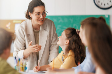 Happy kids and teacher at school