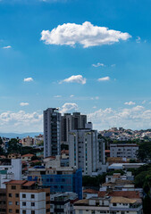 Beautiful blue sky with clouds. Residential buildings. Space for advertising. Vertical.
