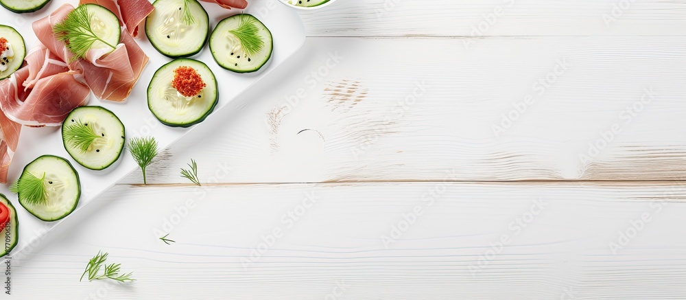 Poster Copy space image: Prosciutto and cucumber on rice cakes on a white wooden table, top view, suitable for adding text.