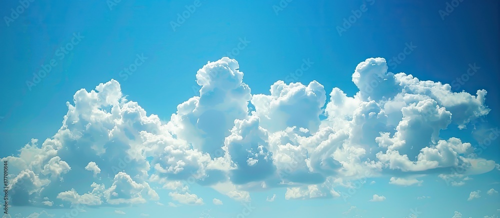 Poster Clouds on a blue sky background create a serene nature scene in this copy space image.