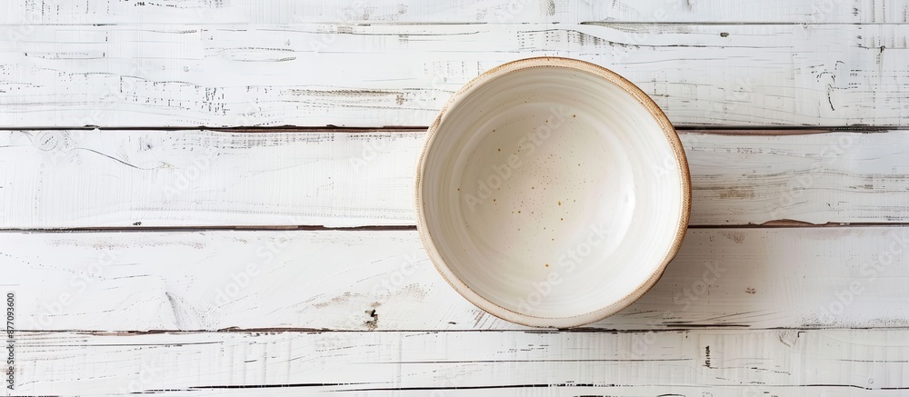 Aufkleber Top-down view of an empty ceramic bowl on a white wooden table, with room for adding text or a copy space image included.
