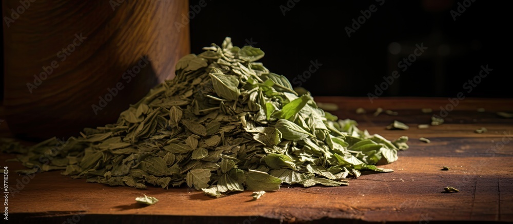Poster dried basil flakes stack on rustic wood, ideal as a background for a copy space image.