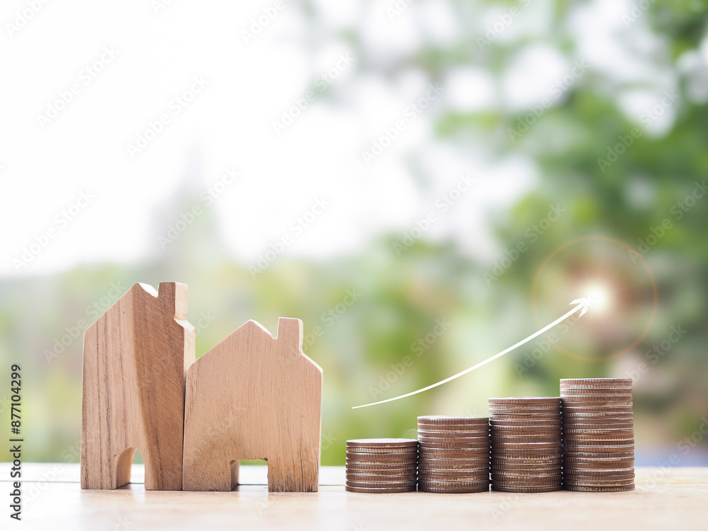 Poster Miniature house and stack of coins with arrow rising. The concept about price of house is growing up, Property investment, House mortgage, Real estate