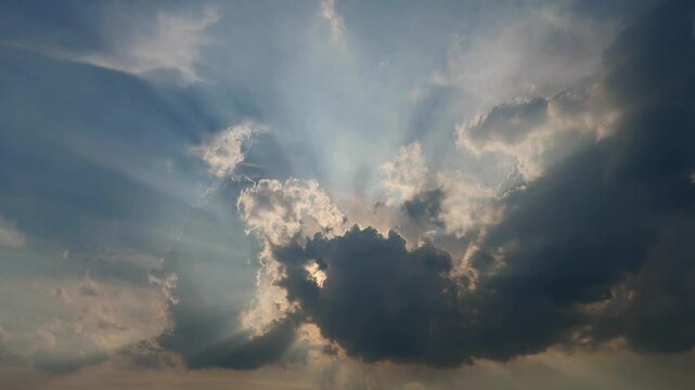Rolling puffy clouds are moving, white and dark clouds time lapse. Clouds running across the blue sky with sunlight. 4k Timelapse footage of white clouds with blue sky in background.