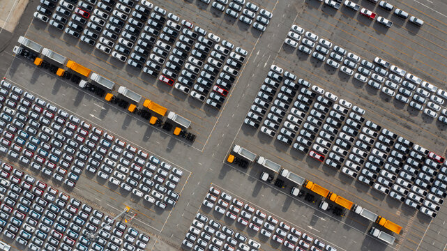 Aerial view of new car stock at distribution center automobile factory, Row of new car for sale in port, New car lined up import and export business logistic to dealership for sale.