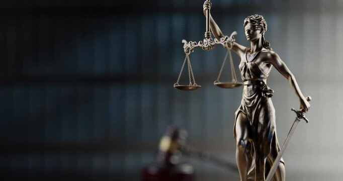 Legal Concept: Themis is the goddess of justice and the judge's gavel hammer as a symbol of law and order on the background of books