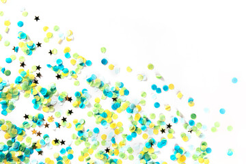 Happy birthday or any holiday festive background with confetti and copy space. Carnival greeting card with golden stars, on a white background