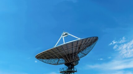 Large satellite dish against a clear blue sky, perfect for depicting communication, technology, and space research themes in stock photography.