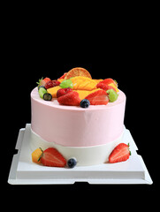 A close-up of a fruitcake on a black background