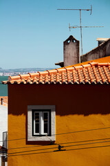 Facade of a building with a small window in the old district of Alfama, Lisbon