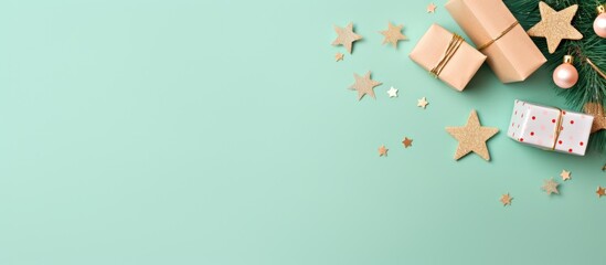 Holiday concepts come to life in a New Year flat lay featuring a homemade wooden toy, a small Christmas tree, and confetti on a mint green background with copy space image.