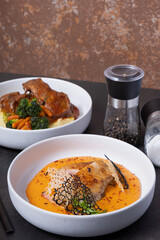 Plate with fried chicken and carrot and potato puree angle view