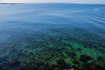 crystal clear water of the Mediterranean sea in summer with a sunny day in the morning