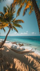 A hammock strung between two palm trees on a pristine beach, with turquoise waters gently lapping at the shore 