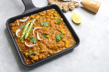 Indian famous dish Mutton matar Kheema Pav or Khima Paav is a minced goat meat curry. Mutton keema cooked with onion, tomatoes, potatoes, green peas along with Indian spices. copy sapce.