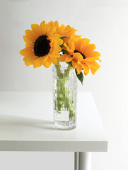 A bouquet of sunflowers on a white tabletop