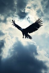 Fototapeta premium A bird flies against a backdrop of cloudy skies, holding another bird in its talons