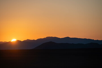 sunrise over the mountains and sand dunes of sossusvlei, namibia