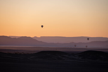 hot air balloons at sunrise in sossusvlei national park, namibia