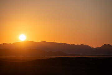sunrise over the mountains and sand dunes of sossusvlei, namibia