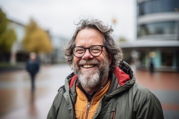 Portrait of a smiling senior man with eyeglasses in the city