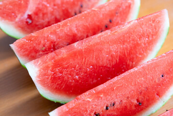 Watermelon slices closeup. Water melon wedges pile, Citrullus lanatus pieces, red wassermelone cuts...