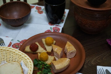 Traditional Ukrainian food on the table in clay dishes.