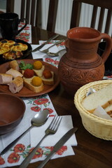 Dinner in clay dishes of traditional Ukrainian dishes.