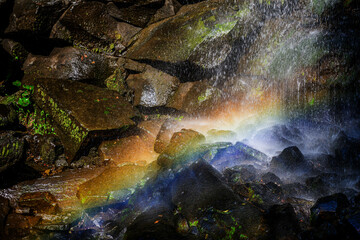 Rainbow in the plunge pool of the Nandi falls, on a hiking trail in the Drakensburg mountains, Kwa-Zulu Natal, South Africa