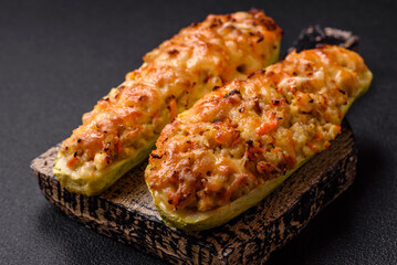Zucchini halves baked with cheese, tomatoes, meat or meat substitute