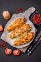 Zucchini halves baked with cheese, tomatoes, meat or meat substitute