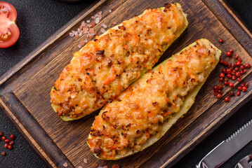 Zucchini halves baked with cheese, tomatoes, meat or meat substitute