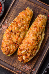 Zucchini halves baked with cheese, tomatoes, meat or meat substitute