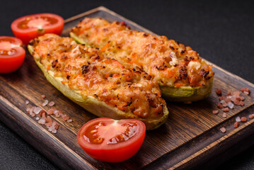 Zucchini halves baked with cheese, tomatoes, meat or meat substitute