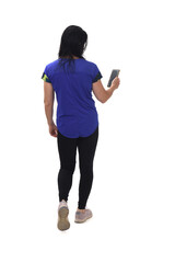 back view of woman walking and looking  her mobile phone on white background