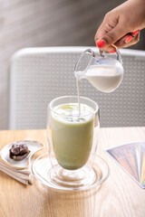 Refreshingly cool matcha latte. A vibrant blend of high-quality matcha green tea and creamy milk, served over ice for a perfectly chilled experience. This invigorating drink boasts a rich and earthy