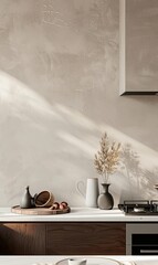 kitchen wall with light gray microcement texture, white marble countertop, beige cabinets, vase of dried flowers, sunlight creating beautiful shadows, simple yet elegant luxury interior design
